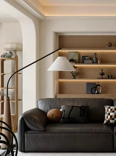 Wooden arc floor lamp, beside a leather sofa