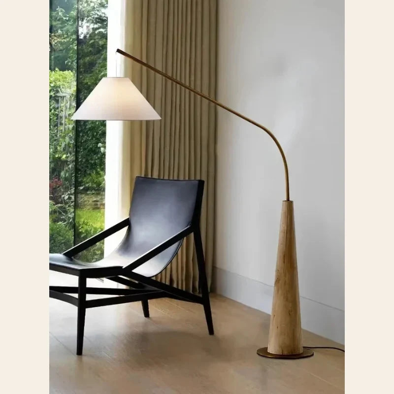Wooden arc floor lamp, over a leather lounge chair