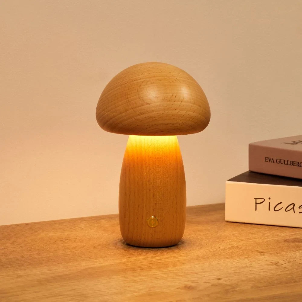 Wooden mushroom cordless table lamp, lit on a wooden table