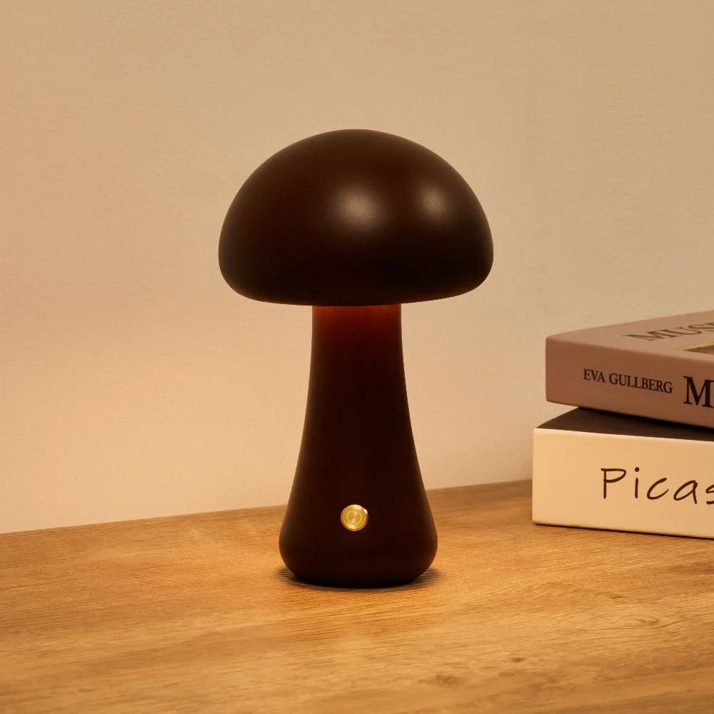 Wooden mushroom cordless table lamp, lit on a wooden table