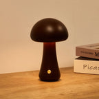 Wooden mushroom cordless table lamp, lit on a wooden table