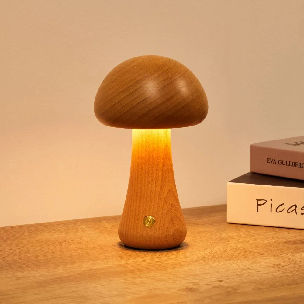Wooden mushroom cordless table lamp, lit on a wooden table