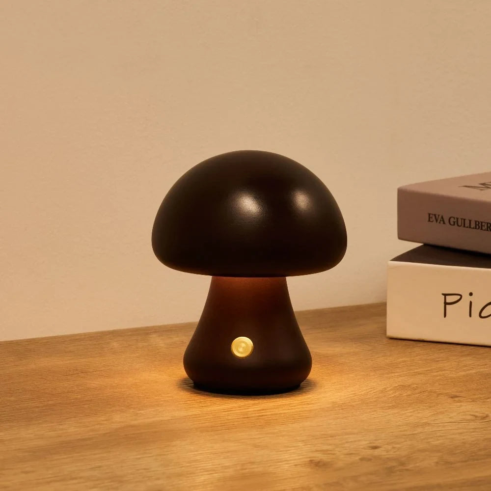 Wooden mushroom cordless table lamp, lit on a wooden table
