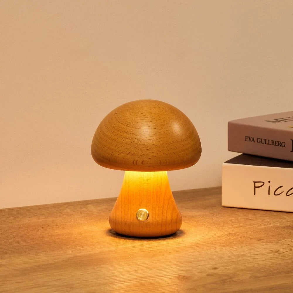 Wooden mushroom cordless table lamp, lit on a wooden table