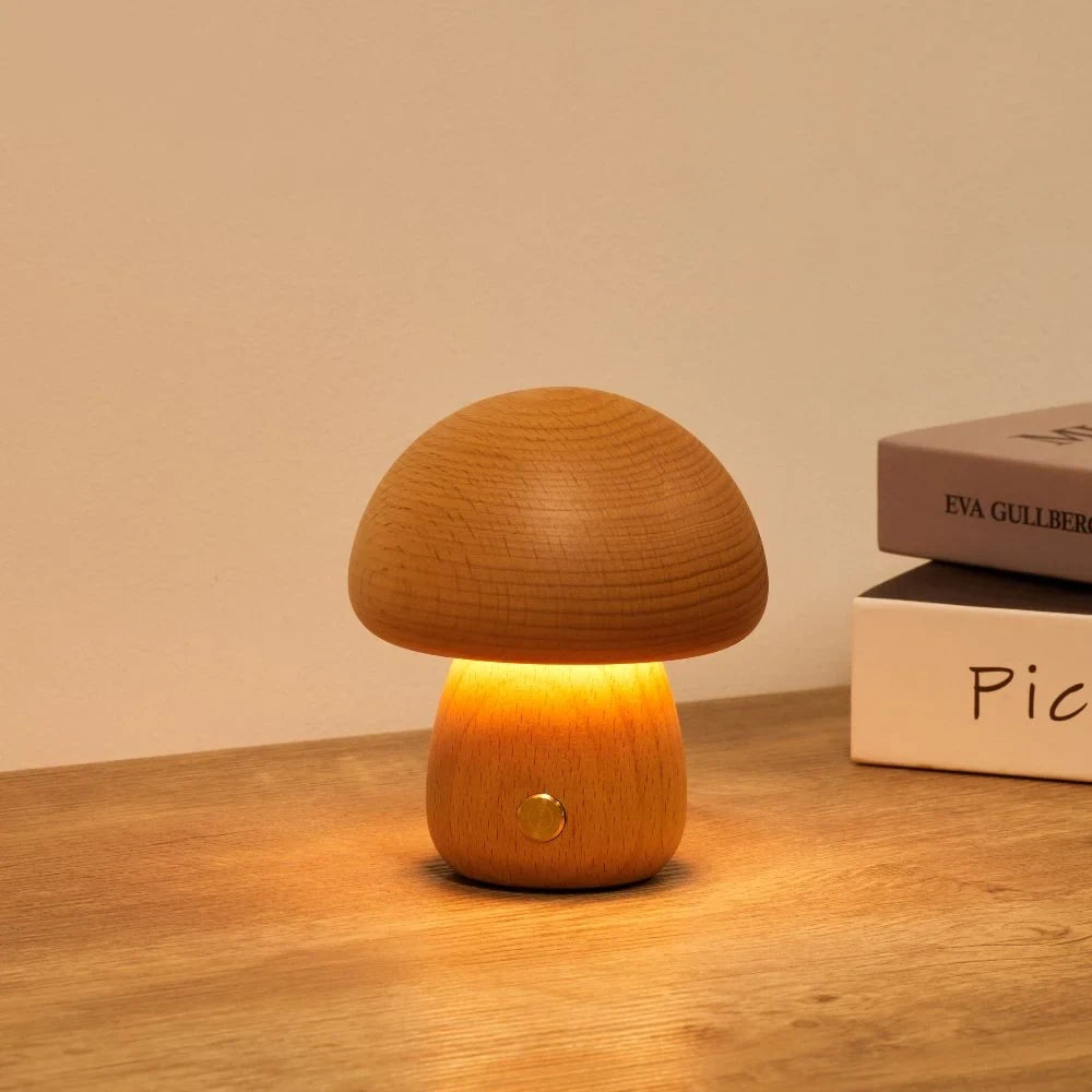 Wooden mushroom cordless table lamp, lit on a wooden table