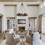 Wooden wheel chandelier with seeded glass shades, above a living room seating area