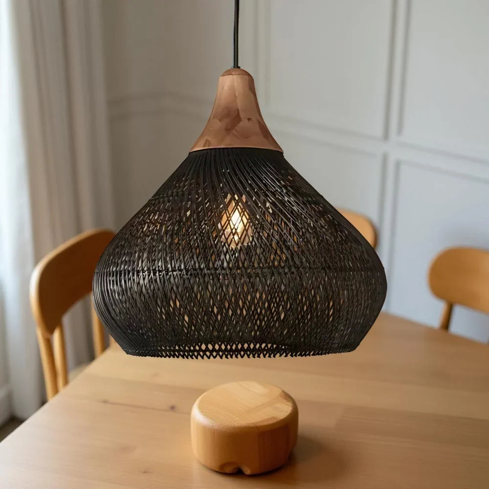Woven rattan teardrop pendant light, in black above a table
