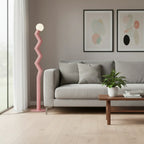 Zigzag floor lamp with frosted glass globe, pink version in a living room